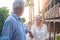 Portrait of one happy and cute senior holding hand of old pensioner wife walking and visiting new places together with the sunset