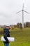 Portrait of one male engineer pointing new area for building wind farm and photovoltaic plant site