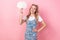 Portrait of optimistic pretty girl with ponytails wear white t-shirt hold mind cloud arm on waist  on pink color