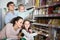 Portrait of ordinary smiling family in local supermarket