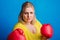 Portrait of an overweight woman with red boxing gloves in studio.