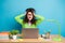 Portrait of overwhelmed girl use laptop work remote touch messy hairstyle isolated over blue color background