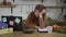 Portrait of overwhelmed young slim beautiful woman in hijab falling asleep sitting in kitchen. Tired exhausted Middle