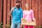 Portrait of pair of farms Working In Garden Together. Image of two happy farmers with instruments on wooden background.