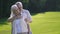 Portrait of passionate senior couple on green lawn