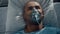 Portrait patient breathing oxygen mask lying in bed hospital emergency unit.