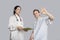 Portrait of patient gesturing okay with doctor holding a clipboard