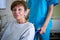 Portrait of patient sitting on wheel chair with nurse standing behind