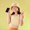 Portrait, peace sign and Asian woman with phone in studio isolated on a yellow background mockup. Makeup, fashion