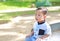 Portrait of peaceful Asian baby boy sitting at the garden with looking up