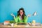 Portrait of peaceful girl sit table meditate have messy pencil hairstyle isolated over blue color background