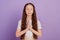 Portrait of peaceful lovely sweet small girl hold palms together yoga lesson on purple background