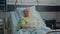 Portrait of pensioner waiting to receive medical support in hospital ward