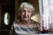 Portrait of a pensioner woman at the table in home.