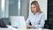 Portrait of pensive businesswoman working typing text or business plan using laptop PC