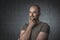 Portrait of pensive caucasian man with t-shirt and dark background