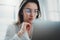 Portrait of pensive confident businesswoman working with laptop computer at modern office.Blurred background.