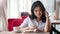 Portrait pensive elegant young female student having good time reading book and drinking coffee