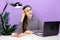 Portrait of pensive troubled secretary employee young female in shirt sitting work at white office desk with pc laptop, looking on