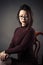 Portrait pensive young girl sitting on chair