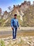 portrait of a person standing on the rocks background mountain