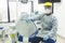 Portrait of a peruvian young dentist with a mask and visor in a dental office. COVID - 19 virus protection.