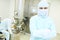 Portrait of pharmaceutical factory worker in protective suit