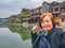 Portrait Photo of asian senior Female backpacker with Scenery view of fenghuang old town