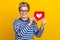 Portrait photo of attractive influencer hold red heart figure like repost her new content advert isolated on yellow