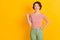 Portrait photo of curious happy girl with bob hair pointing looking at copyspace smiling isolated on vibrant yellow