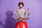 Portrait photo of female bike rider shocked keeping lipstick helmet striped jumper staring isolated on bright violet