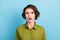 Portrait photo of funny nervous confused girl with short brunette hair wearing green shirt starring surprised with