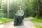 Portrait photo of a handicapped man in a electric wheelchair in nature