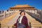 Portrait photo of Senior asian women with `Taihedian ` palace in the Forbidden Palace Gate at beijing
