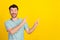 Portrait photo of young attractive guy excited crazy pointing empty space advertisement isolated on yellow color