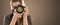 Portrait of a photographer covering her face with camera.