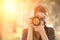 Portrait of a photographer covering her face with camera.