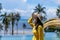 Portrait photography Yellow dress traveler Asian girl wearing hat and sunglass acting post beside the beach on sunshine at Island