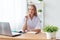 Portrait of physician working in her office sitting workplace.