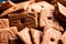 A portrait of a pile of brown cookies called speculoos or speculaas in Belgium or the Netherlands. The spiced biscuit is very