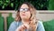 Portrait of pleasant fat woman eating unhealthy chips having positive emotion looking at camera