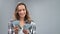 Portrait of pleasant young casual woman counting cash dollar money smiling isolated on gray