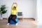 Portrait plus size woman doing exercise with fitness ball in home gym. Overweight woman sitting on a pilates ball and Stretching