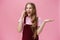 Portrait of popular outgoing and talkative young attractive girl in overalls waving raised hand during conversation