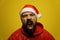 Portrait Portrait of a mad modern santa claus. She screams, rejoices, gets angry. Close up. Isolate on a yellow background.of an