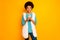 Portrait of positive afro american girl use smartphone follow bloggers comment post wear teal sweater white fluffy