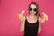 Portrait of positive attractive young woman holding two bananas