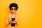 Portrait of positive cheerful afro american girl in sunglass use her smartphone type text post comments feedback read