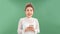 Portrait of positive cheerful girl use smart phone look copy space share social media news isolated over green background