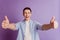 Portrait of positive confident reliable guy raise two thumbs up on purple background